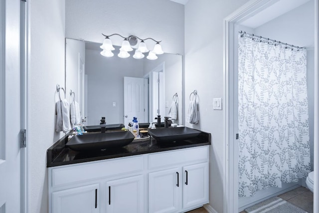 15413 Echo Hills Dr, Austin, TX 78717 - bathroom with double vanity, curtained shower, and tile patterned floors