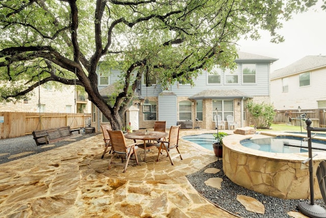 15413 Echo Hills Dr, Austin, TX 78717 - fenced backyard featuring an in-ground hot tub, a patio, and outdoor dining space