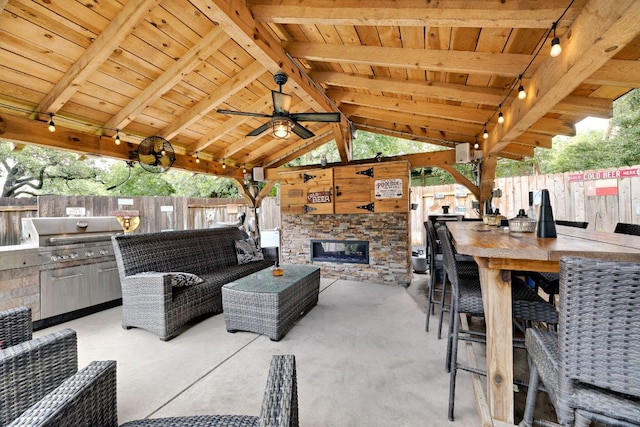 15413 Echo Hills Dr, Austin, TX 78717 - fenced backyard featuring an outdoor kitchen, a patio area, ceiling fan, a gazebo, and an outdoor living space with a fireplace