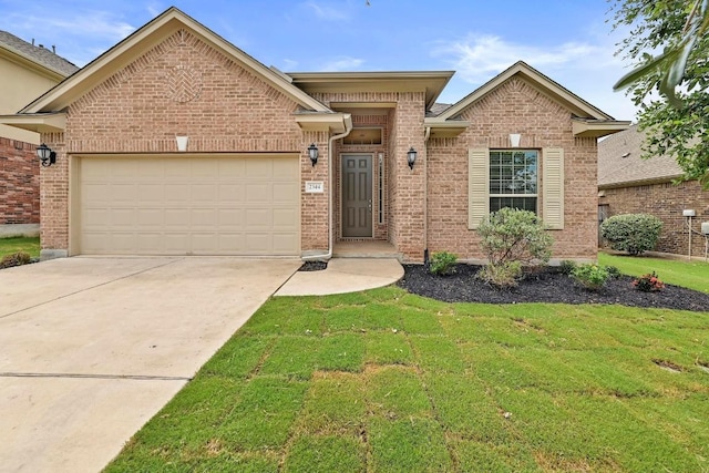 2344 Broken Wagon Dr, Leander, TX 78641 - view of front facade featuring driveway, a front lawn, a garage, and brick siding