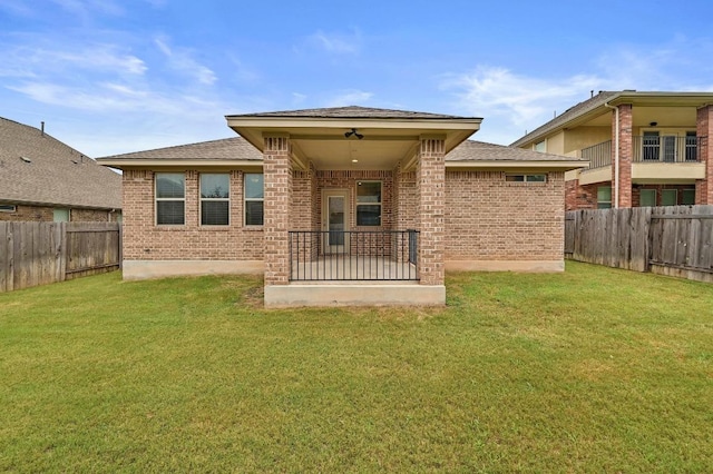 2344 Broken Wagon Dr, Leander, TX 78641 - rear view of property with brick siding, a fenced backyard, and a shingled roof