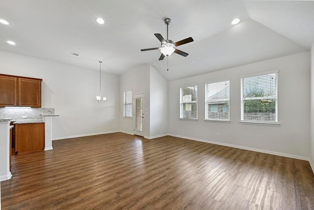 2344 Broken Wagon Dr, Leander, TX 78641 - unfurnished living room featuring lofted ceiling, healthy amount of natural light, a chandelier, recessed lighting, and dark wood finished floors
