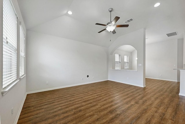 2344 Broken Wagon Dr, Leander, TX 78641 - unfurnished living room featuring lofted ceiling, recessed lighting, a ceiling fan, dark wood-type flooring, and arched walkways