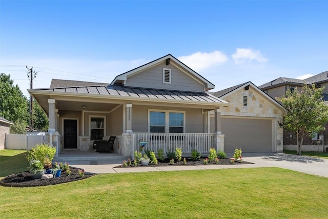 19105 Obed River Dr, Pflugerville, TX 78660 - view of front of home featuring a standing seam roof, a porch, an attached garage, a front yard, and driveway