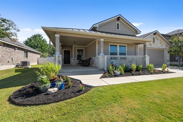 19105 Obed River Dr, Pflugerville, TX 78660 - view of front of property featuring a standing seam roof, a front lawn, covered porch, a garage, and a metal roof