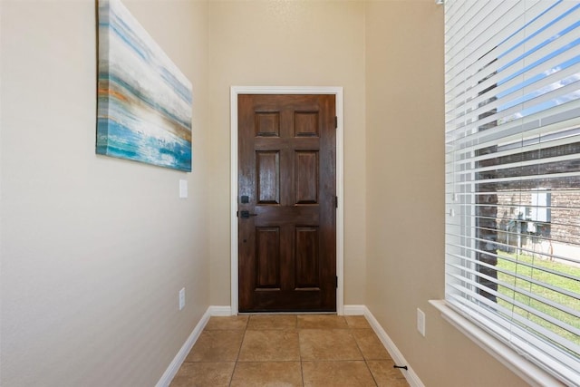 19105 Obed River Dr, Pflugerville, TX 78660 - doorway with light tile patterned floors and baseboards