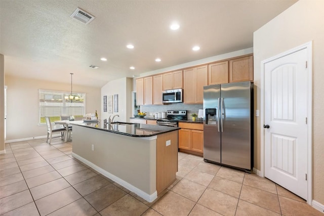 19105 Obed River Dr, Pflugerville, TX 78660 - kitchen featuring stainless steel appliances, dark countertops, light tile patterned floors, tasteful backsplash, and recessed lighting