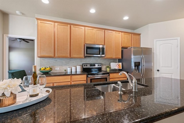 19105 Obed River Dr, Pflugerville, TX 78660 - kitchen featuring stainless steel appliances, ceiling fan, backsplash, dark stone counters, and recessed lighting
