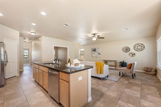19105 Obed River Dr, Pflugerville, TX 78660 - kitchen with stainless steel appliances, a kitchen island with sink, light tile patterned floors, ceiling fan, and plenty of natural light