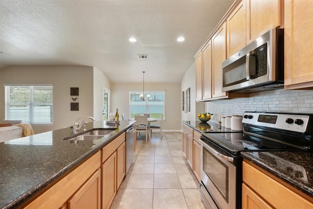 19105 Obed River Dr, Pflugerville, TX 78660 - kitchen with stainless steel appliances, backsplash, recessed lighting, dark stone counters, and light tile patterned flooring