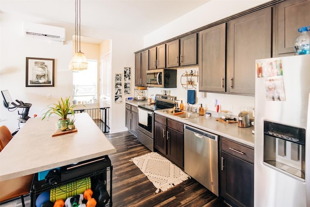 8601 W Gate Blvd Unit 4103, Austin, TX 78745 - kitchen with appliances with stainless steel finishes, a wall mounted AC, dark wood finished floors, light countertops, and dark brown cabinetry