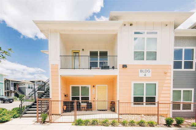 8601 W Gate Blvd Unit 4103, Austin, TX 78745 - rear view of property featuring board and batten siding and a patio