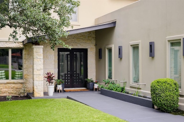 114 Medalist St, Lakeway, TX 78734 - property entrance with french doors, stone siding, and stucco siding