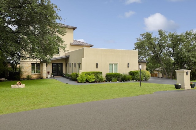 114 Medalist St, Lakeway, TX 78734 - view of front of property featuring a standing seam roof, stucco siding, a front yard, and french doors
