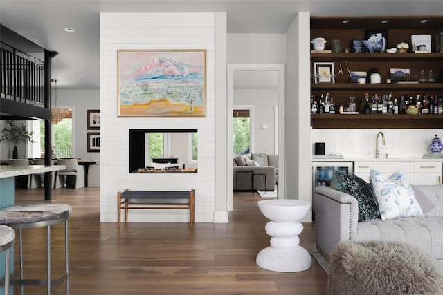 114 Medalist St, Lakeway, TX 78734 - living area featuring wet bar, beverage cooler, wood finished floors, recessed lighting, and a fireplace