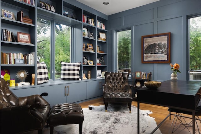114 Medalist St, Lakeway, TX 78734 - sitting room with a decorative wall and wood finished floors