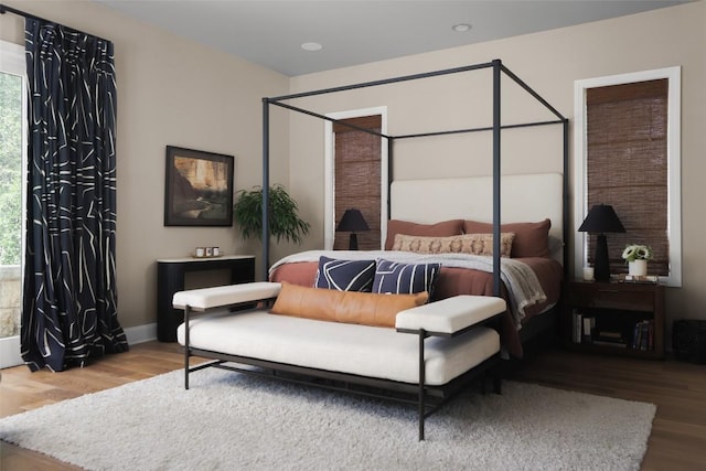 114 Medalist St, Lakeway, TX 78734 - bedroom with wood finished floors, multiple windows, and recessed lighting