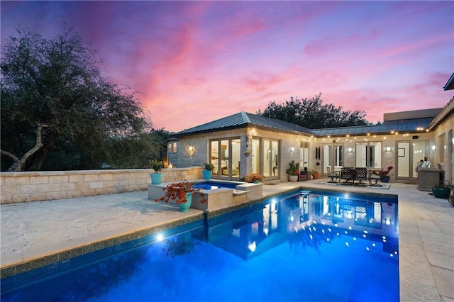 114 Medalist St, Lakeway, TX 78734 - outdoor pool with an in-ground hot tub, a patio, and french doors