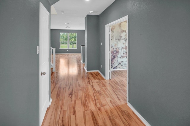 123 Brittany Ln, Bastrop, TX 78602 - corridor featuring light wood-style floors and an upstairs landing