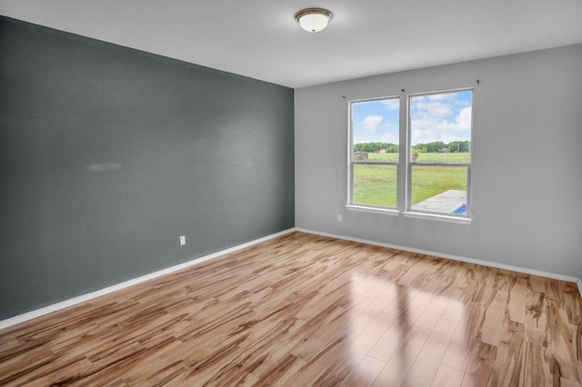123 Brittany Ln, Bastrop, TX 78602 - unfurnished room featuring wood finished floors and baseboards