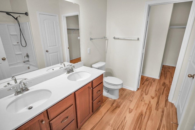 123 Brittany Ln, Bastrop, TX 78602 - bathroom with wood finished floors, double vanity, shower / bath combination, and a closet