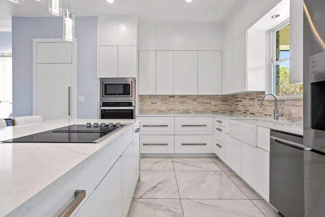 14430 Tuscola Cir, Austin, TX 78734 - kitchen with stainless steel appliances, light marble finish floors, white cabinetry, recessed lighting, and light stone counters