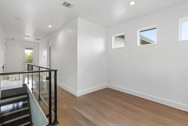 14430 Tuscola Cir, Austin, TX 78734 - hall featuring attic access, wood finished floors, recessed lighting, and an upstairs landing