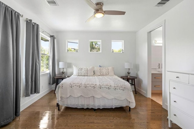 14430 Tuscola Cir, Austin, TX 78734 - bedroom with multiple windows, dark wood finished floors, ensuite bath, and a ceiling fan