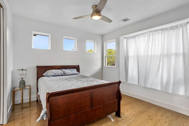 14430 Tuscola Cir, Austin, TX 78734 - bedroom with multiple windows, light wood-style floors, and ceiling fan