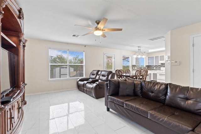 161 Prairie Verbena Dr, Kyle, TX 78640 - living room featuring a chandelier, ceiling fan, light marble finish flooring, and healthy amount of natural light