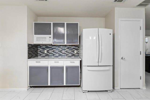 161 Prairie Verbena Dr, Kyle, TX 78640 - kitchen with white appliances, light countertops, light marble finish flooring, and tasteful backsplash