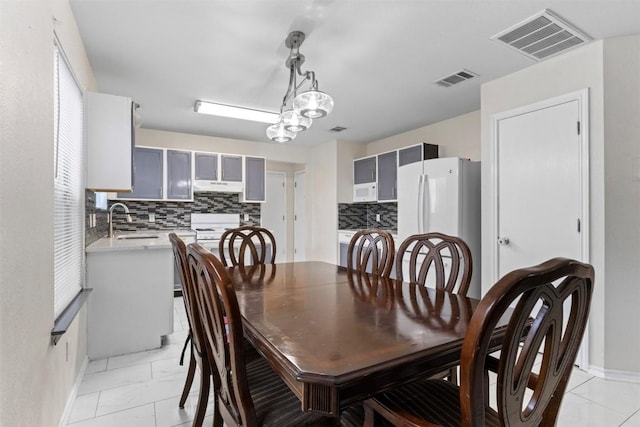 161 Prairie Verbena Dr, Kyle, TX 78640 - dining room featuring light marble finish floors and baseboards