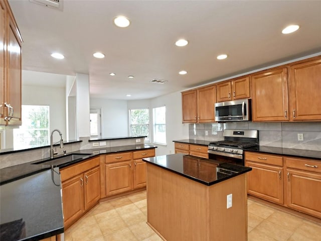 106 S Gadwall Ln, Cedar Park, TX 78613 - kitchen featuring appliances with stainless steel finishes, recessed lighting, backsplash, a center island, and dark stone countertops