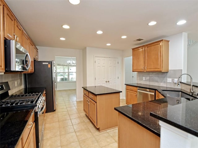 106 S Gadwall Ln, Cedar Park, TX 78613 - kitchen with appliances with stainless steel finishes, a center island, backsplash, recessed lighting, and dark stone counters