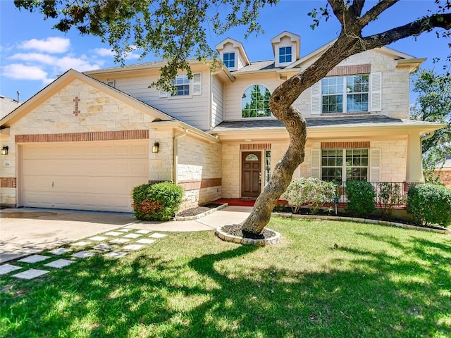 106 S Gadwall Ln, Cedar Park, TX 78613 - traditional-style house with stone siding, a garage, a front lawn, and driveway