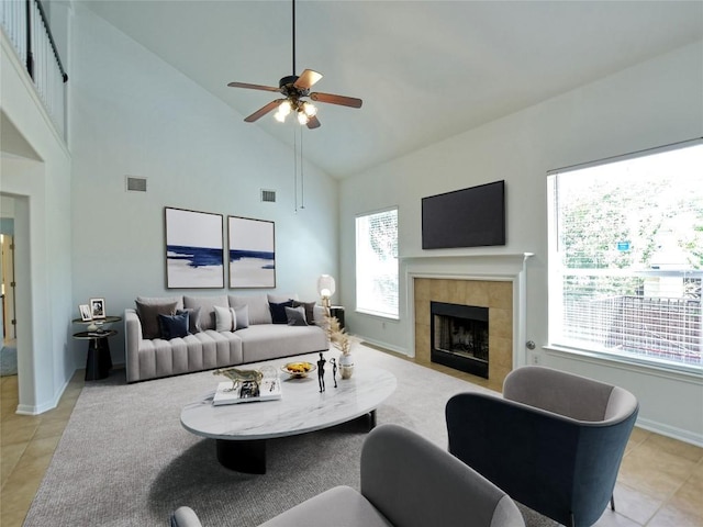 106 S Gadwall Ln, Cedar Park, TX 78613 - living room featuring a tile fireplace, high vaulted ceiling, ceiling fan, and light tile patterned flooring