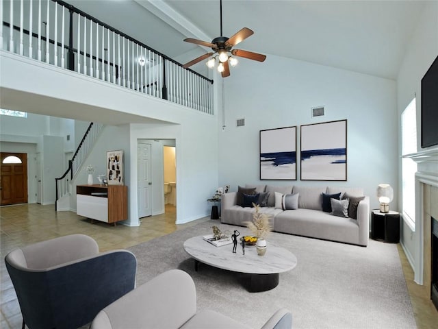 106 S Gadwall Ln, Cedar Park, TX 78613 - living area featuring high vaulted ceiling, ceiling fan, stairs, and a tiled fireplace