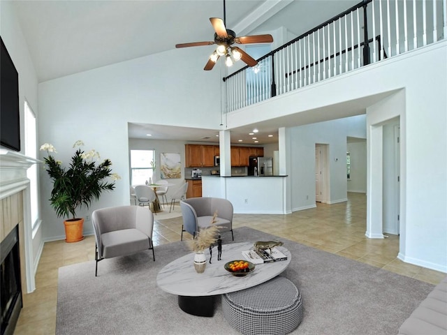 106 S Gadwall Ln, Cedar Park, TX 78613 - living room with a fireplace, a high ceiling, ceiling fan, and light tile patterned flooring