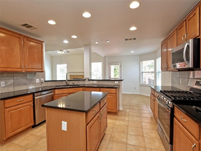 106 S Gadwall Ln, Cedar Park, TX 78613 - kitchen featuring appliances with stainless steel finishes, recessed lighting, backsplash, a kitchen island, and a peninsula