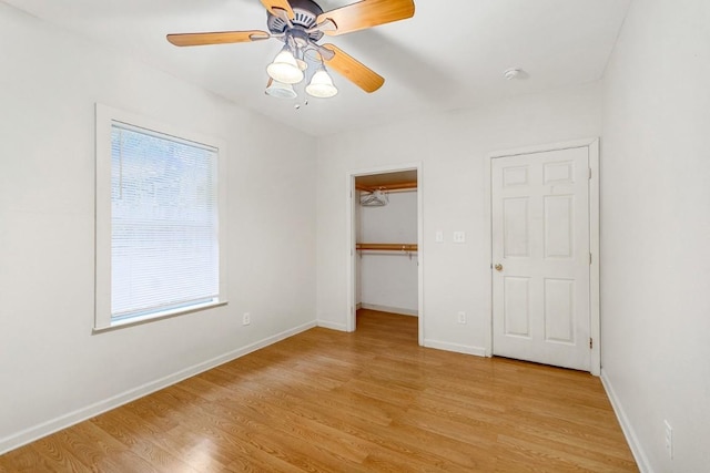 2834 Pearl St, Austin, TX 78705 - unfurnished bedroom featuring light wood-style flooring, multiple windows, a walk in closet, and a ceiling fan