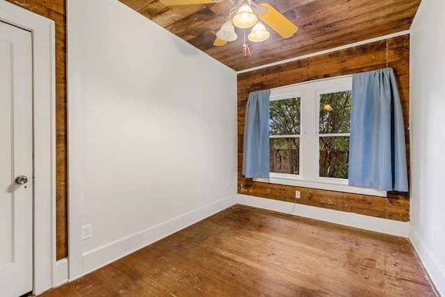 2834 Pearl St, Austin, TX 78705 - empty room with wooden ceiling, wood finished floors, a ceiling fan, and wooden walls