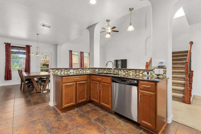 204 Lake Livingston Dr, Georgetown, TX 78628 - kitchen with dishwasher, brown cabinets, tasteful backsplash, ceiling fan, and dark stone countertops