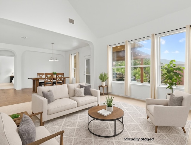 204 Lake Livingston Dr, Georgetown, TX 78628 - living area featuring arched walkways, light tile patterned floors, and high vaulted ceiling