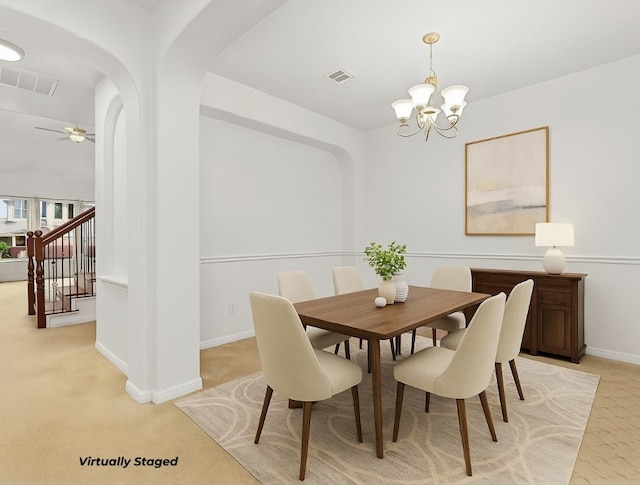 204 Lake Livingston Dr, Georgetown, TX 78628 - dining room featuring a chandelier, stairs, light colored carpet, arched walkways, and ceiling fan