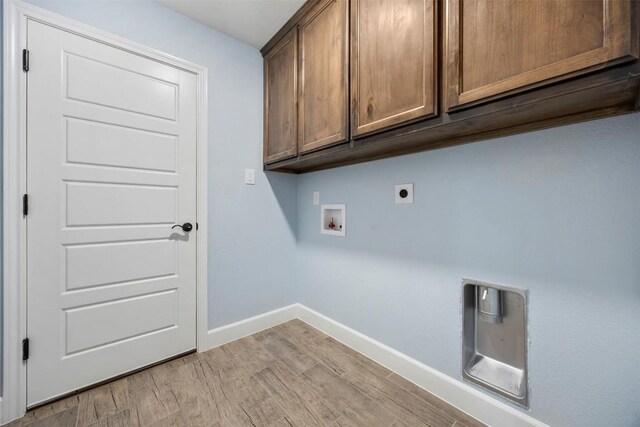 2660 Cowgirl Trl, Belton, TX 76513 - washroom featuring cabinet space, electric dryer hookup, washer hookup, and light wood-style flooring