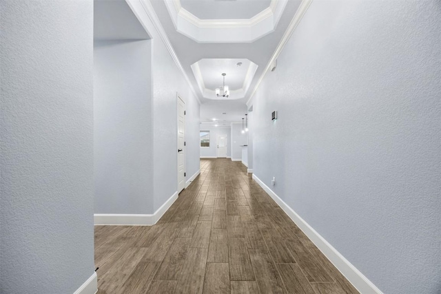 2660 Cowgirl Trl, Belton, TX 76513 - hallway featuring a raised ceiling, dark wood finished floors, ornamental molding, a textured wall, and a chandelier