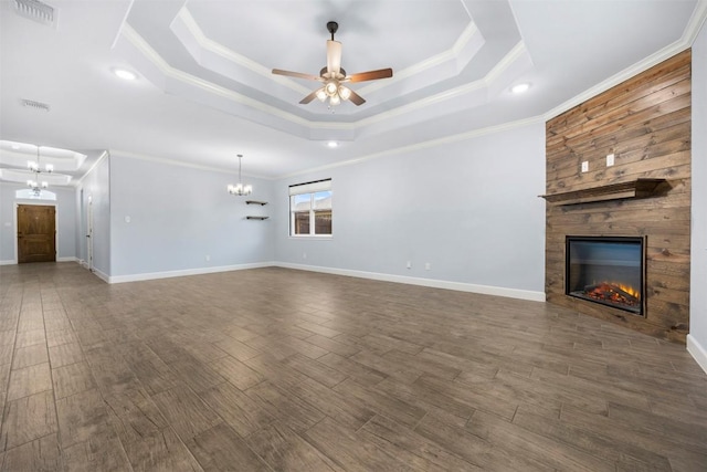 2660 Cowgirl Trl, Belton, TX 76513 - unfurnished living room featuring a chandelier, a tray ceiling, a fireplace, ceiling fan, and crown molding