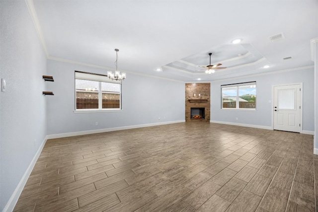 2660 Cowgirl Trl, Belton, TX 76513 - unfurnished living room featuring a raised ceiling, wood finish floors, a ceiling fan, ornamental molding, and a large fireplace