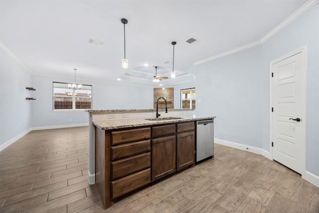 2660 Cowgirl Trl, Belton, TX 76513 - kitchen featuring stainless steel dishwasher, light wood-style floors, crown molding, a center island with sink, and plenty of natural light