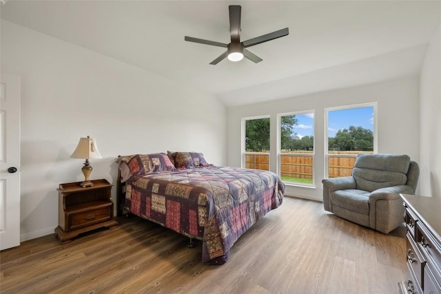 608 Haleys Cv, Leander, TX 78641 - bedroom featuring wood finished floors, vaulted ceiling, and a ceiling fan